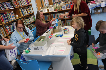 East Broadway Elementary School kindergartner Jordan Bushman made a purchase at the PTA's annual holiday boutique.