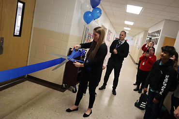 Librarian Caitlin Stabile cut the ribbon for the grand opening.