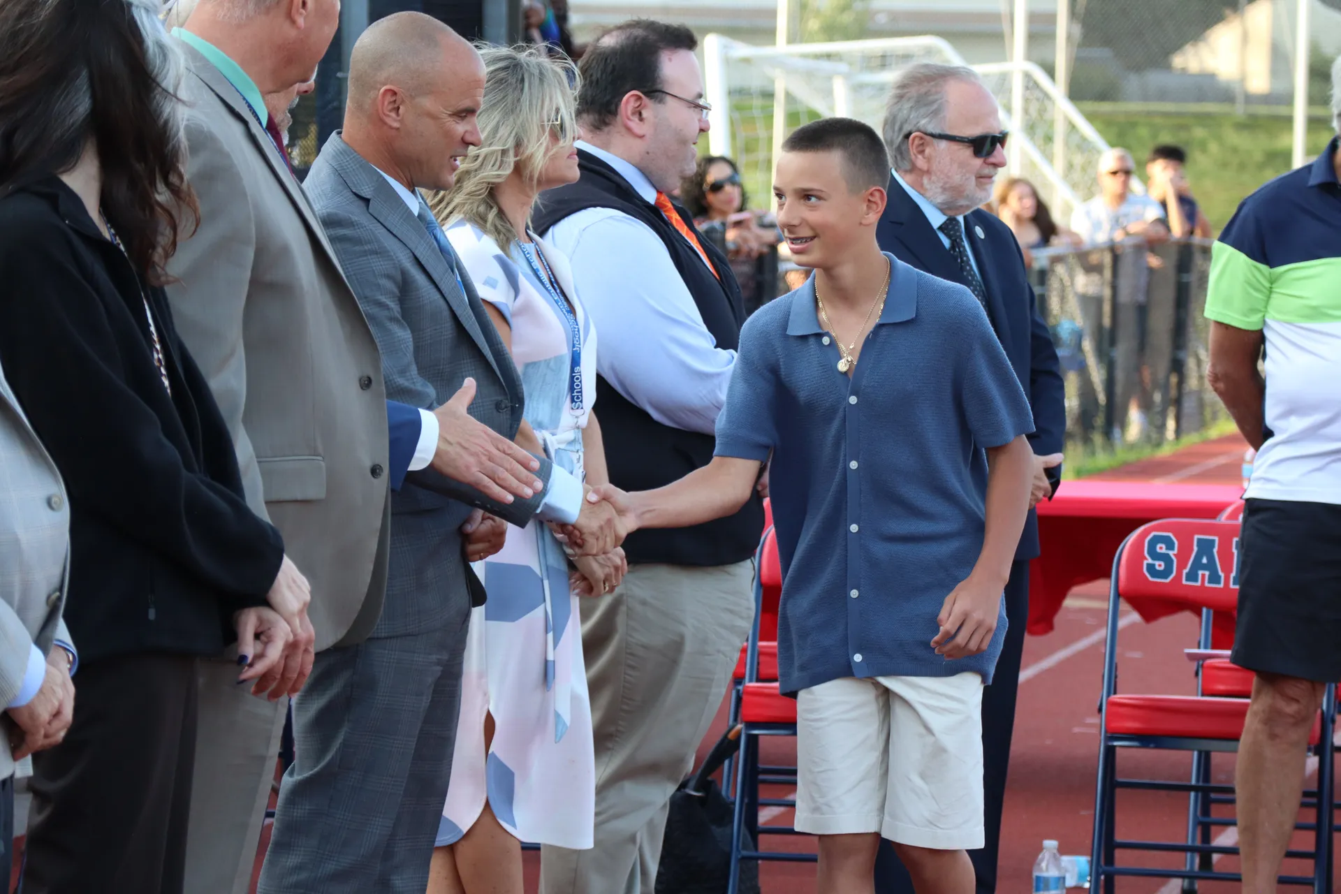 Graduates, now high schoolers, shook hands with trustees and administrators.