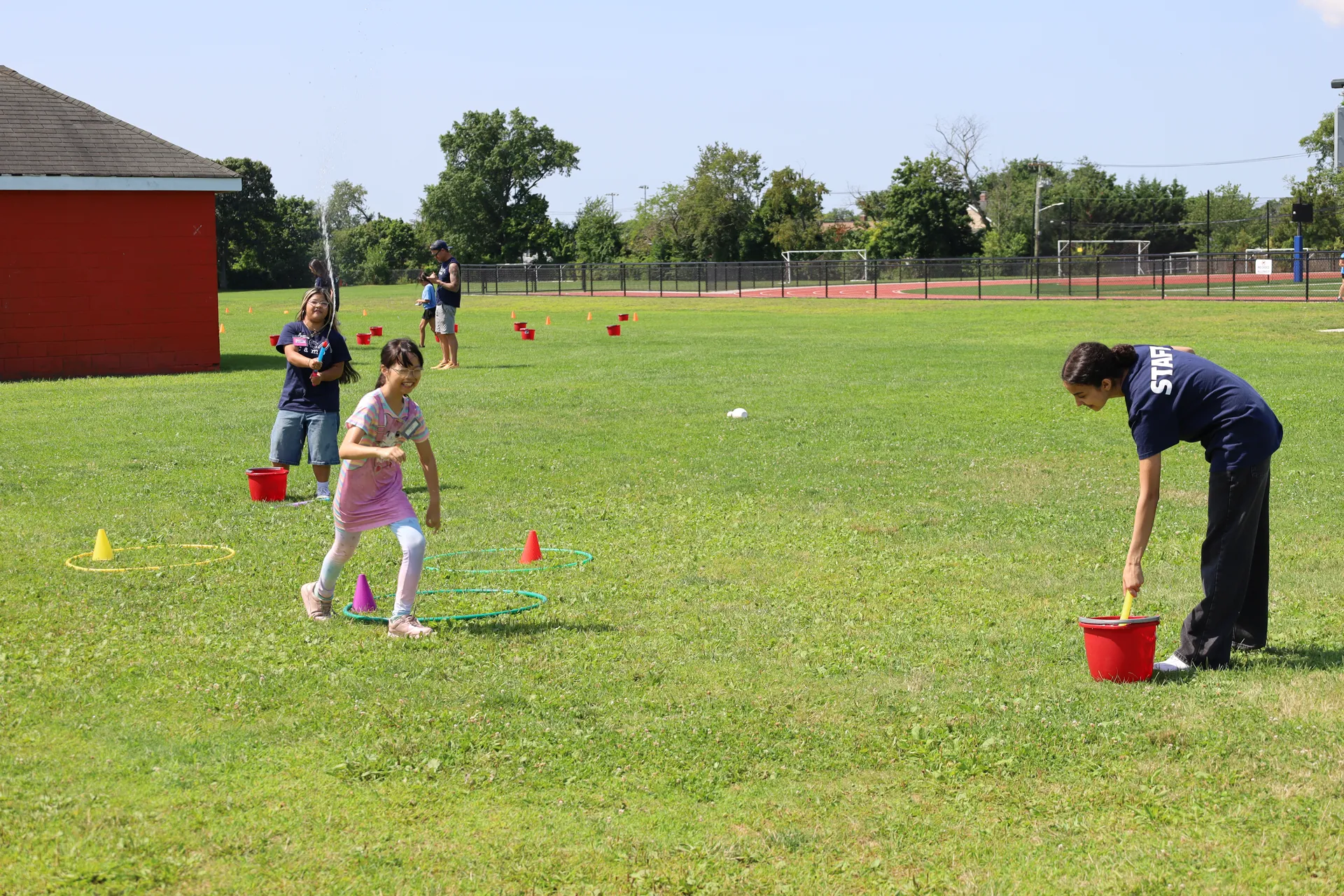 High school student volunteers kept the excitement going as they kept students cool with water sprayers.